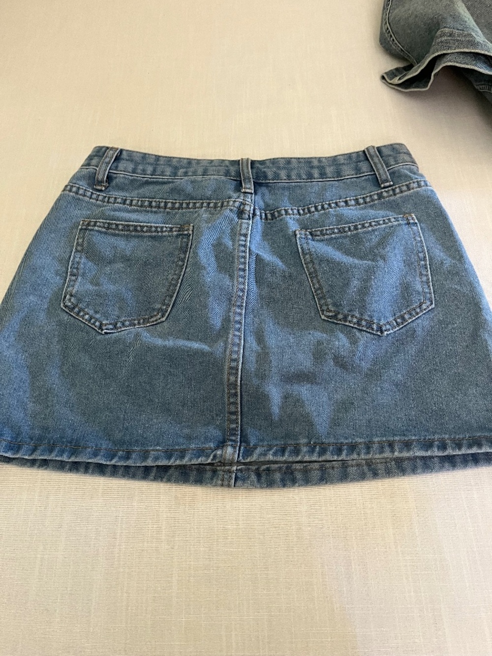 Pearl beaded Kirt on front denim mini